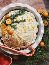 High angle view of sweet food with candy cane in bowl on table