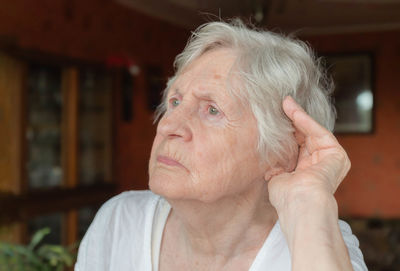 Senior woman looking away at home