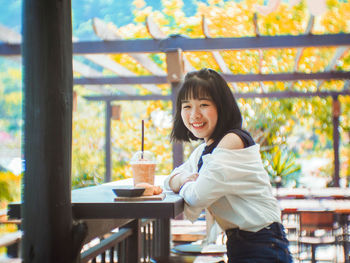 Portrait of woman with coffee cup on table