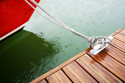 Close-up of rope tied to wooden surface