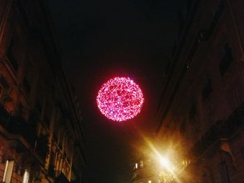 Low angle view of illuminated lights at night