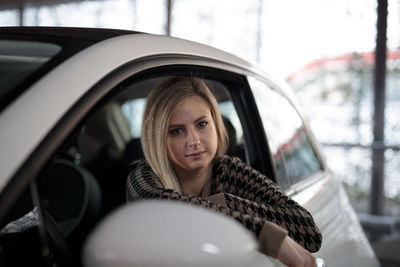 Portrait of young woman in car