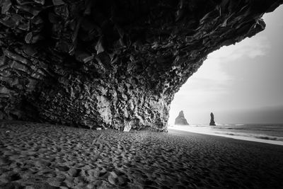 Scenic view of sea seen through cave