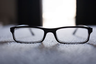 Close-up of eyeglasses on rug at home