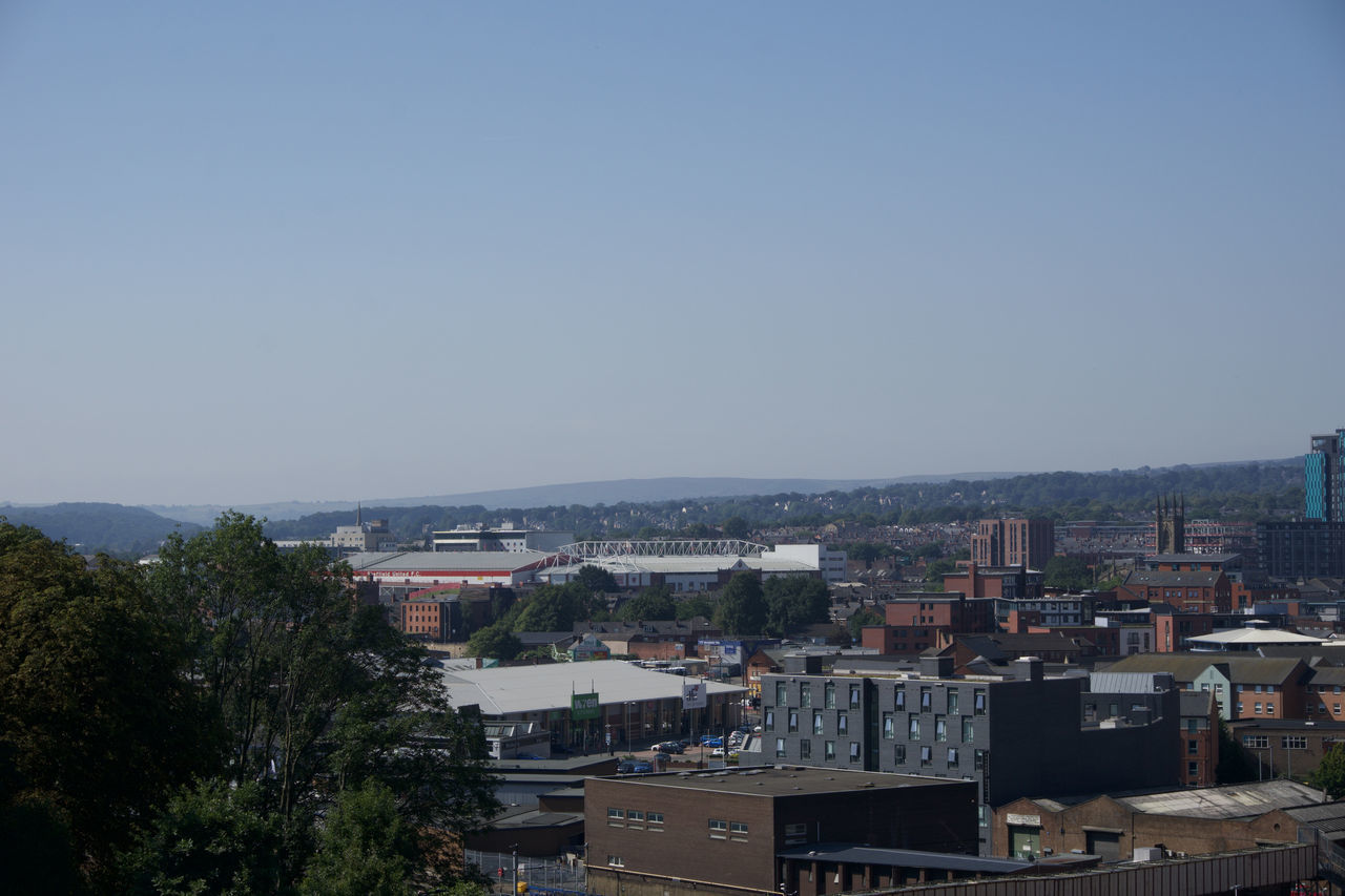 HIGH ANGLE SHOT OF TOWNSCAPE AGAINST CLEAR SKY