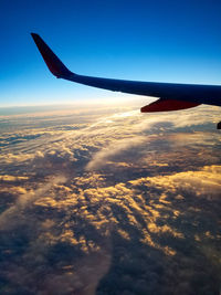 Aerial view of airplane wing against sky