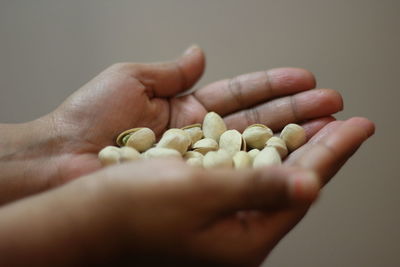 Close-up of hands holding pistachio nuts