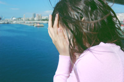 Woman in sea against sky