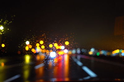 Close-up of illuminated road in city at night