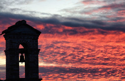 Low angle view of cross against sky during sunset