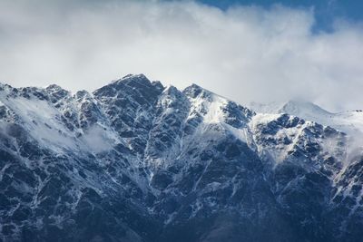 Scenic view of snow covered mountains against sky