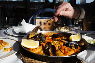 Close-up of person preparing food on table