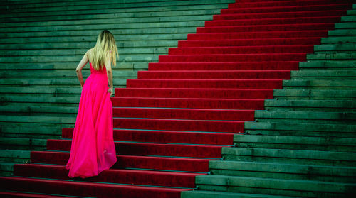 Rear view of woman standing on staircase