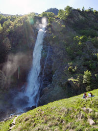 Scenic view of waterfall against sky