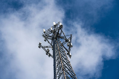 Low angle view of communications tower against sky