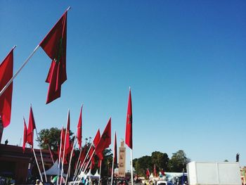 Low angle view of flags flag against blue sky