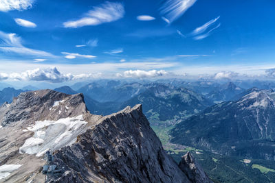 Scenic view of snowcapped mountains against blue sky