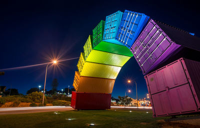 Illuminated built structure against sky at night