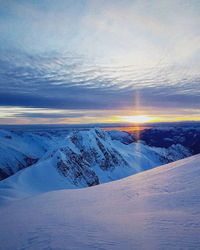 Scenic view of snowcapped mountains against sky during winter