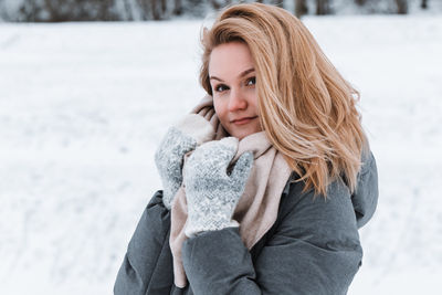 Young woman standing on snow