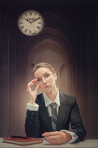 Young businesswoman sitting on table