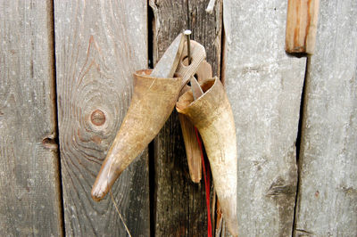 A pair of cow horns hanging on a wooden barn