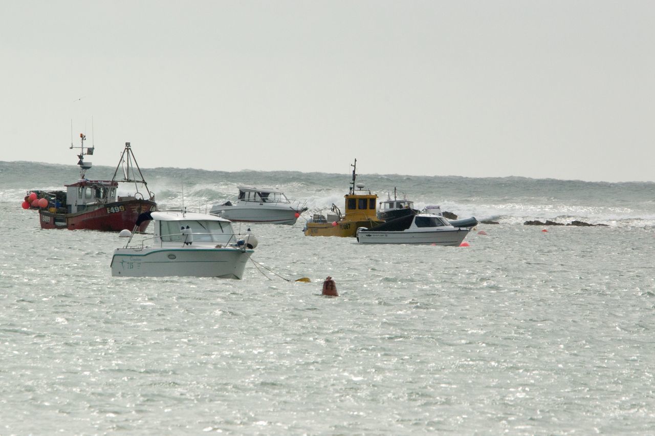 BOAT SAILING ON SEA AGAINST CLEAR SKY