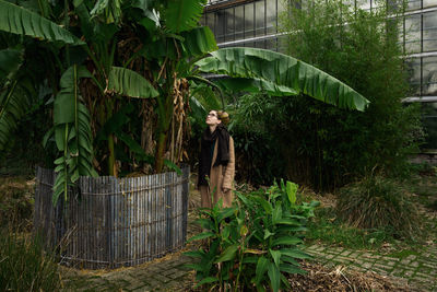 Man standing by tree