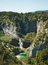 Scenic view of waterfall against sky