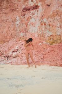 Side view of woman standing on beach
