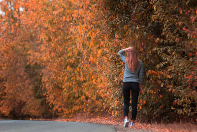 Full length of man standing by tree during autumn