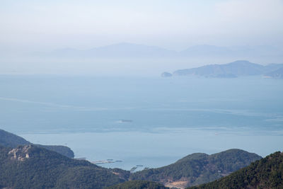 Scenic view of sea and mountains against sky