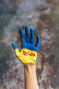 Cropped hand of woman with text