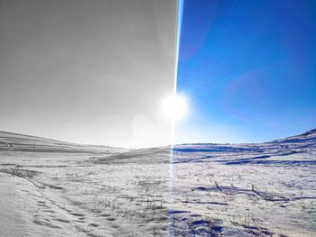 Scenic view of snowcapped landscape against sky