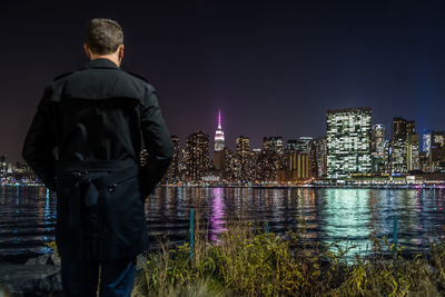 Woman standing in illuminated city at night