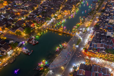 High angle view of illuminated city buildings at night