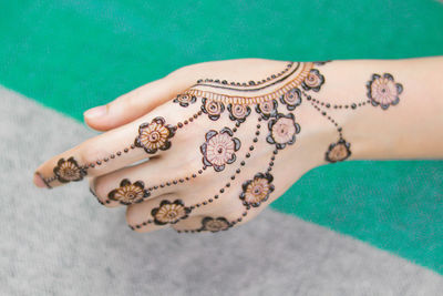 Close-up of woman with henna tattoo