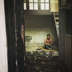 Man sitting in abandoned room