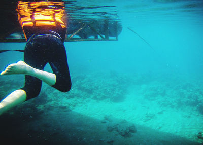 Low section of woman swimming in sea