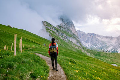 Rear view of man on mountain against sky