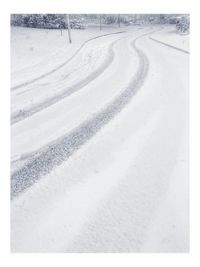 Tire tracks on snow covered sand