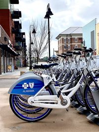 Bicycles parked on street by buildings in city