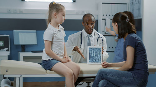 Doctor showing x-ray image through tablet pc