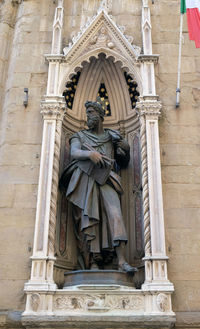 Low angle view of statue against temple