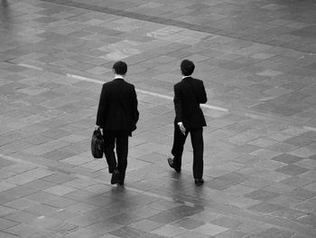 Rear view of people walking in corridor