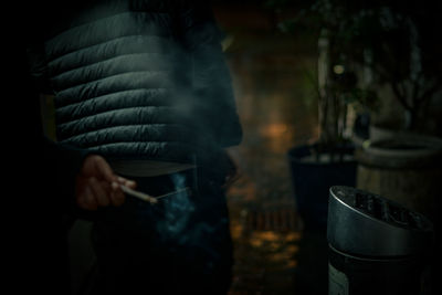 Midsection of woman holding cigarette