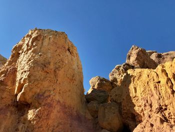 Low angle landscape of yellow rock formations at the interpretive paint mines park in colorado