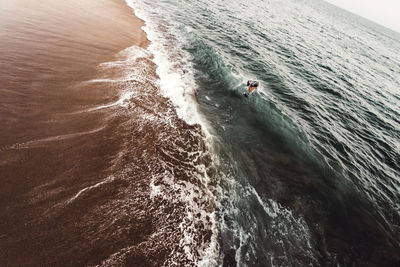 Man drowning in sea at beach