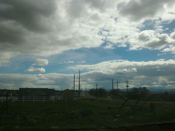 Scenic view of landscape against cloudy sky