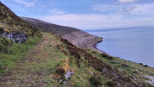 Scenic view of sea and mountains against sky